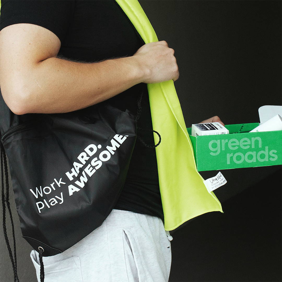 Man with Green Roads gear and gift box